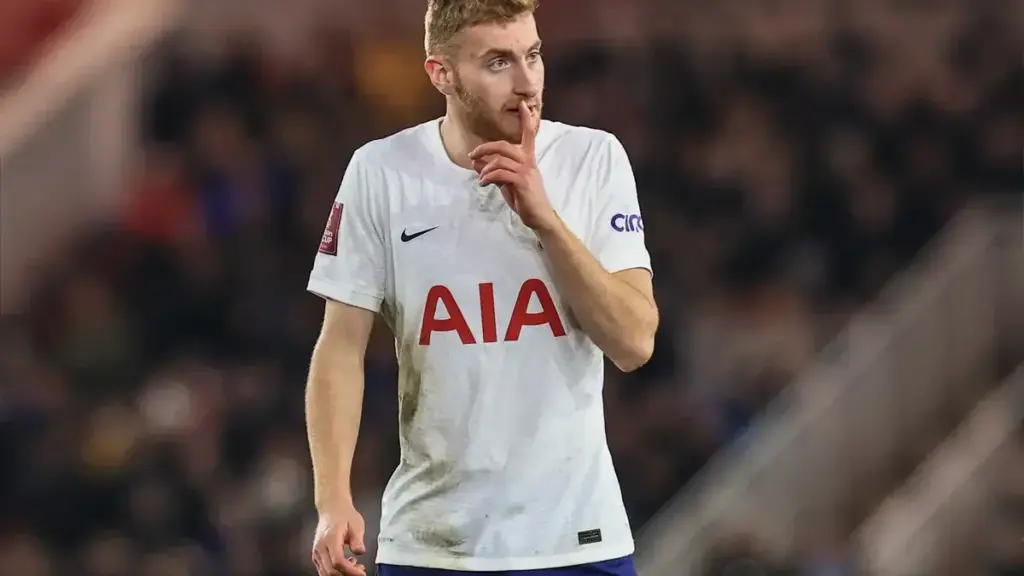 Dejan Kulusevski injury: Dejan Kulusevski in a Tottenham Hotspur kit gesturing with a finger to his lips during a match.