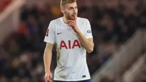Dejan Kulusevski injury: Dejan Kulusevski in a Tottenham Hotspur kit gesturing with a finger to his lips during a match.