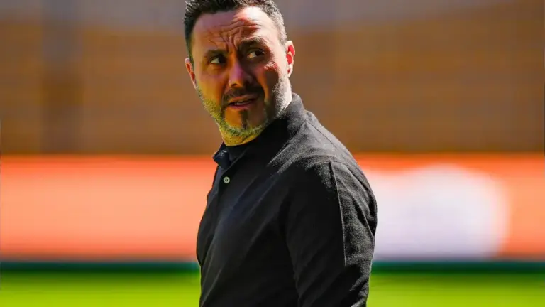 Roberto De Zerbi looking tense and thoughtful on the touchline.
